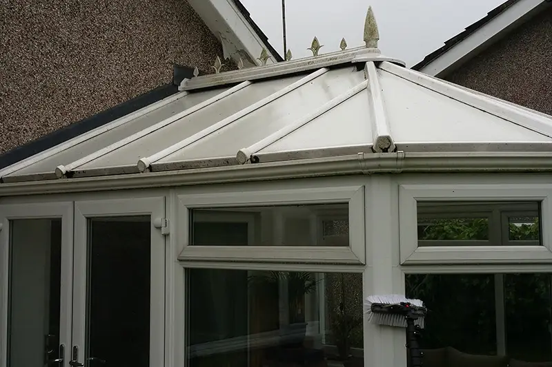 Conservatory roof before cleaning — grime and algae buildup on panels