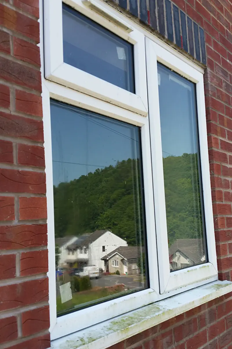 Window before cleaning — smudges and grime on glass and frame